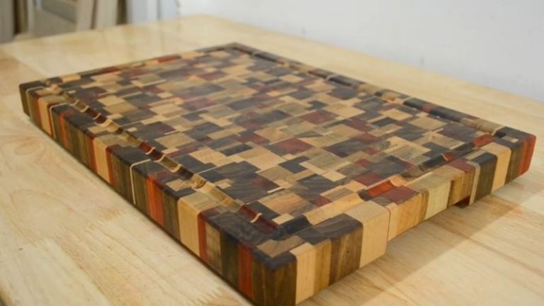 End grain cutting board with rubber feet installed, showing a thick board raised for better drying.