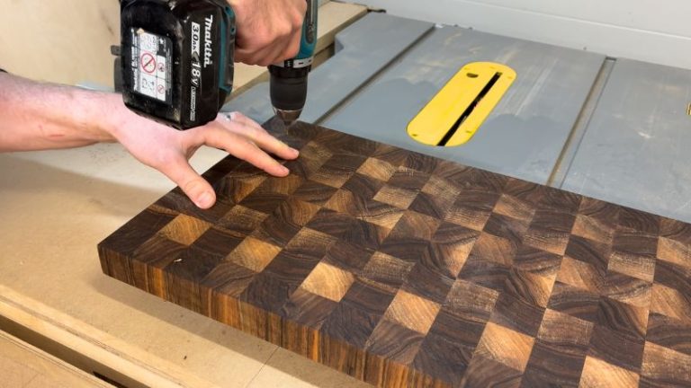 Predrilling shallow pilot holes in a cutting board underside before driving M2 screws for rubber feet.