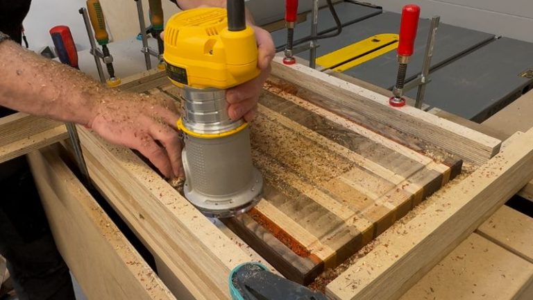 Routing a juice groove clockwise around the cutting board to keep the router stable and avoid tear-out.