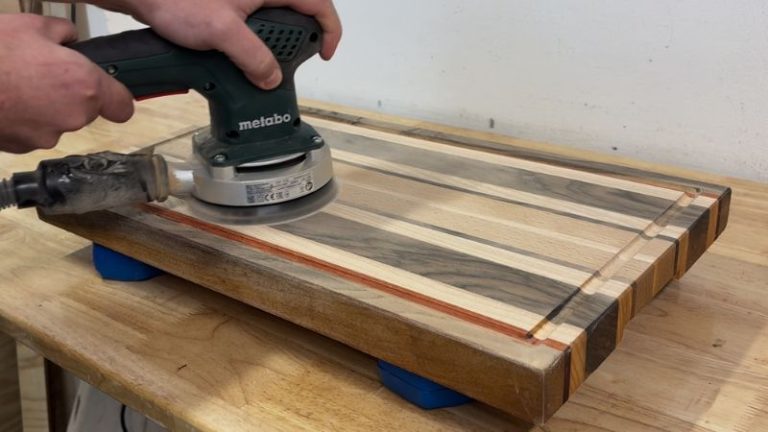 Final sanding of a cutting board after raising the grain, moving from 120 grit to 300 grit.