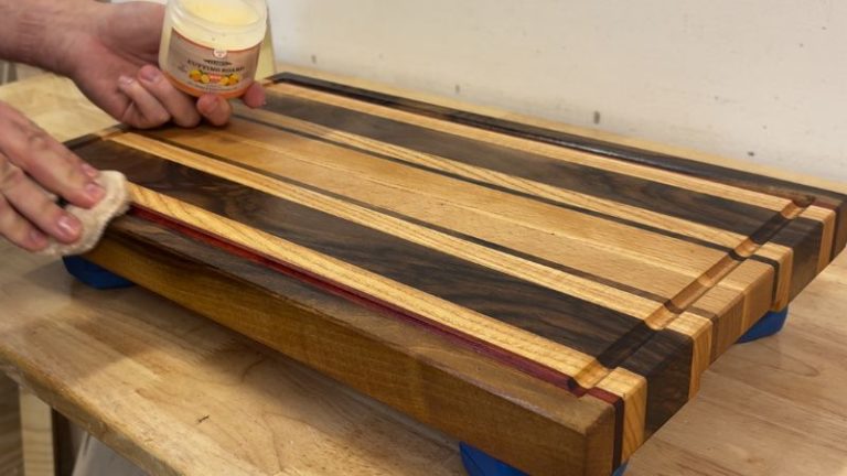 Applying Clark’s cutting board wax to the surface of a refinished cutting board for extra protection.