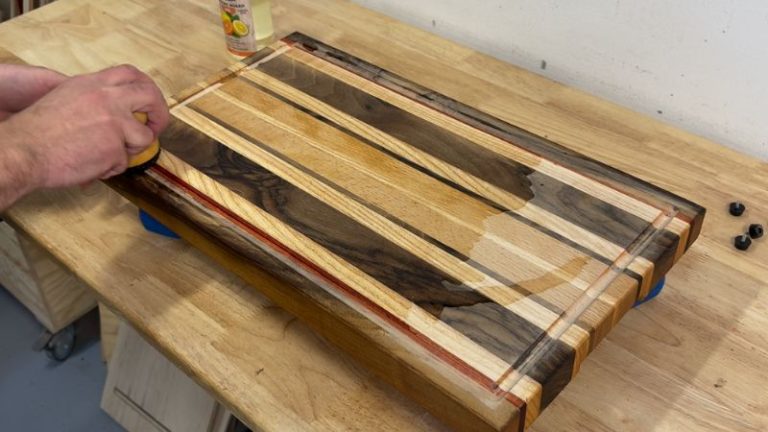 Applying the first coat of cutting board oil to a sanded cutting board to bring the wood color back.
