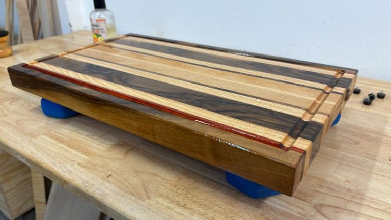 Close-up of walnut darkening after oiling, showing contrast with lighter woods on an edge grain cutting board.