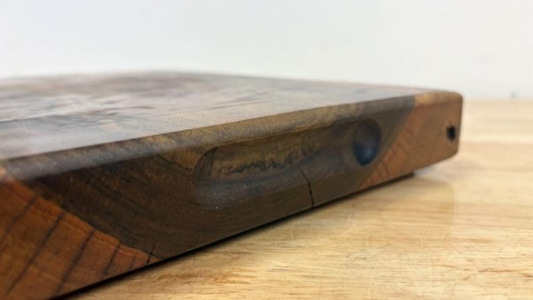 Finished side finger groove (side slot) handle centered on a cutting board, routed with a round nose bit about 5 to 8 mm deep.