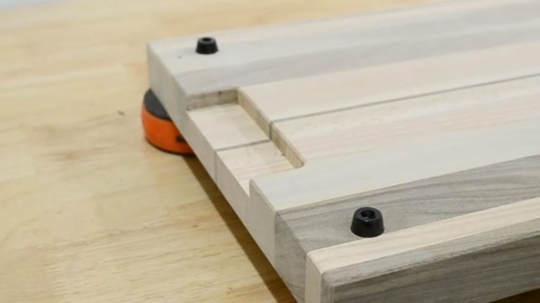 Finished underside finger grip handle routed into a cutting board using a straight bit, about 100 mm wide and 8 mm deep.