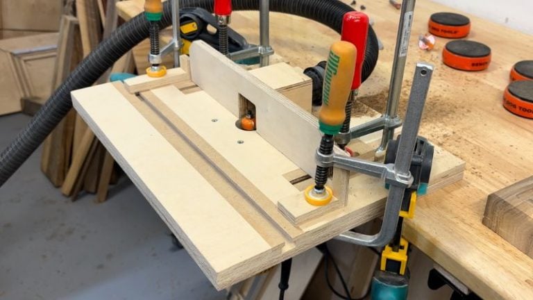 Router table setup with left and right stoppers positioned to control the length of an underside finger grip handle cut.
