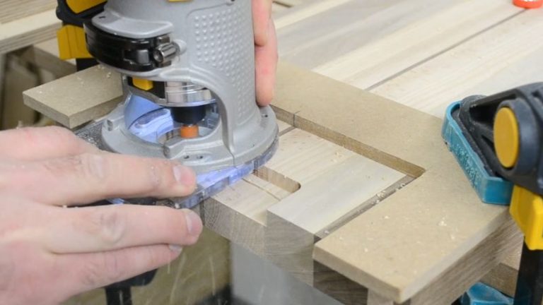 Routing an underside finger grip handle on a cutting board with a straight bit using light passes and a handle jig.