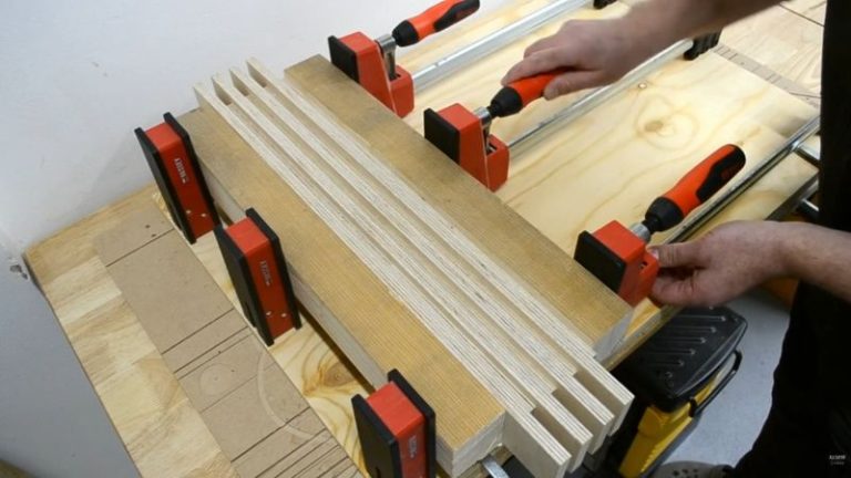 Gluing paired Baltic birch plywood pieces with clamps to make thicker frame parts.