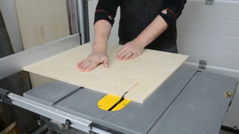 Cutting plywood inside panels on a table saw for a DIY planer stand with storage.