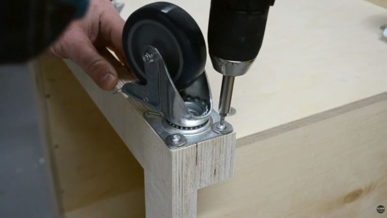 Predrilling holes and mounting locking casters to the bottom of a rolling planer stand.