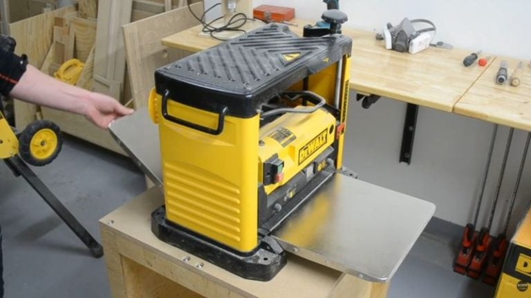 Dewalt planer placed on the MDF tabletop of a DIY planer stand for a test fit.