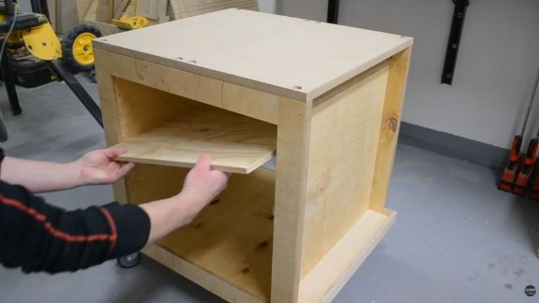 Installing a center shelf inside a rolling planer stand to create two large storage compartments.