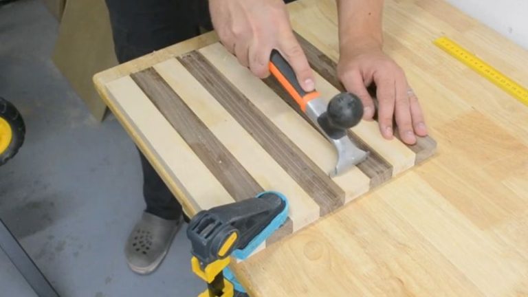 Cleaning glue squeeze-out from a clamped wood panel and later scraping dried glue before flattening.