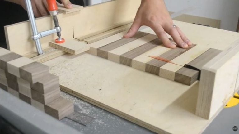 Setting up a crosscut sled to cut a glued panel into 36 mm segments to create chessboard squares.