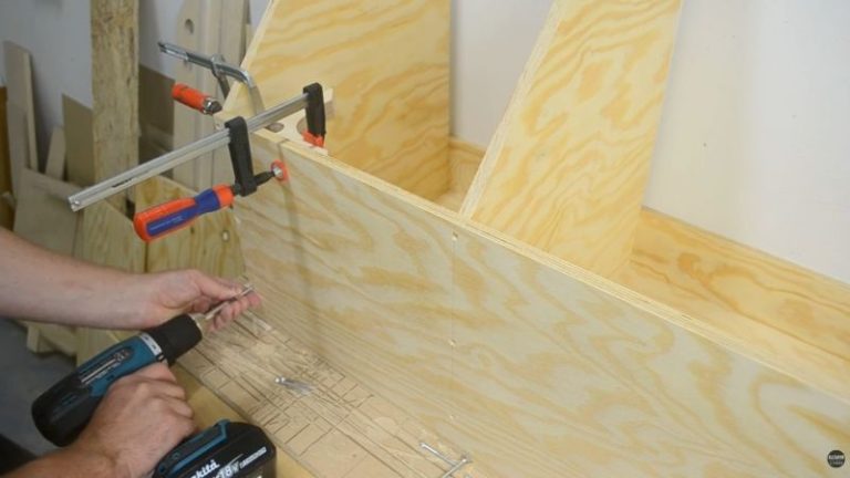Clamping the front panel to the lumber cart frame before predrilling and fastening with screws.