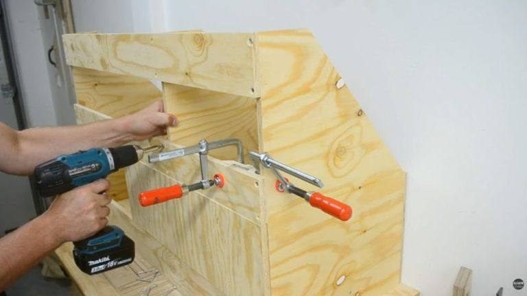 Installing the back central support to prevent boards from falling out.