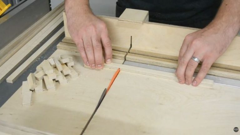 Crosscutting 15 mm plywood strips into 40 mm long blocks using a table saw crosscut sled for repeatable cuts.