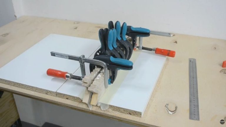 Clamping a laminated wooden mallet handle blank made from plywood panels and a walnut core layer.