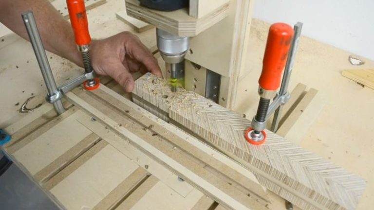 Preparing the wooden mallet handle tenon end by drilling two relief holes and cutting wedge slots down to the holes using a table saw tenon jig.