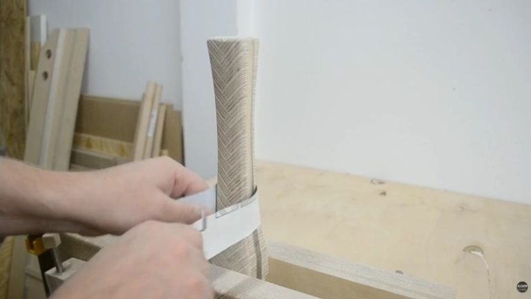 Sanding a wooden mallet handle in a Moxon vise with sanding sheets to refine the final grip shape.