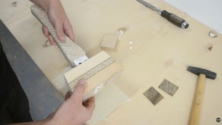Installing the wooden mallet handle into the head with glue.