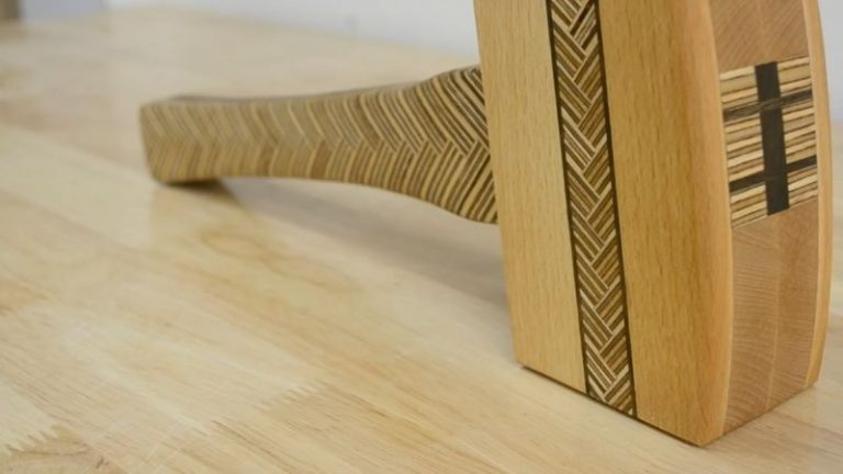 Finished wooden mallet with beech, walnut, and Baltic birch plywood pattern after oiling, showing rich color and clean edges.