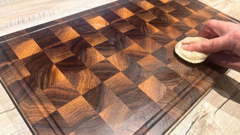 Buffing wax onto a walnut cutting board after oiling as part of a regular care routine.