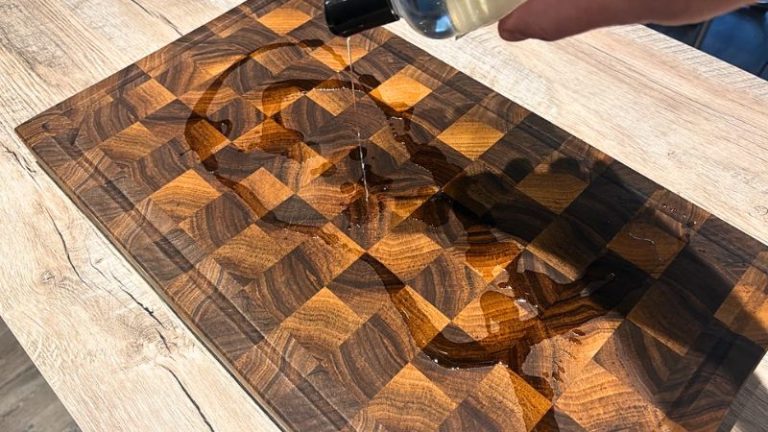 Pouring cutting board oil onto a walnut cutting board to nourish the wood during maintenance.