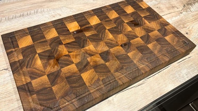 Walnut end grain cutting board after cooking with stains and signs of normal kitchen use before cleaning and maintenance.