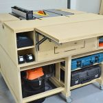Mobile table saw workbench with storage, outfeed table, and modular design for a small workshop or garage.