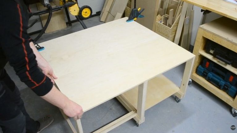 Base frame for a DIY mobile table saw workbench made from Baltic birch plywood with locking casters and top platform.