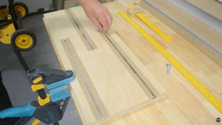 Base of a DIY drill lathe made from laminated Baltic birch plywood with homemade T-tracks for adjustable components.