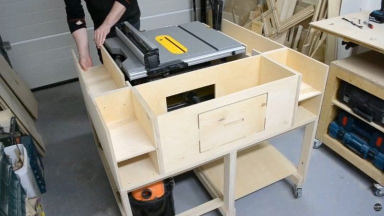 Upper cabinet section for a DIY mobile table saw workbench with shelves, dust hose access, and cutouts for the saw fence and controls.