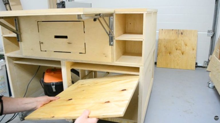 Final assembly of a DIY mobile table saw workbench with tabletop cutouts, shelves, and side panels installed.