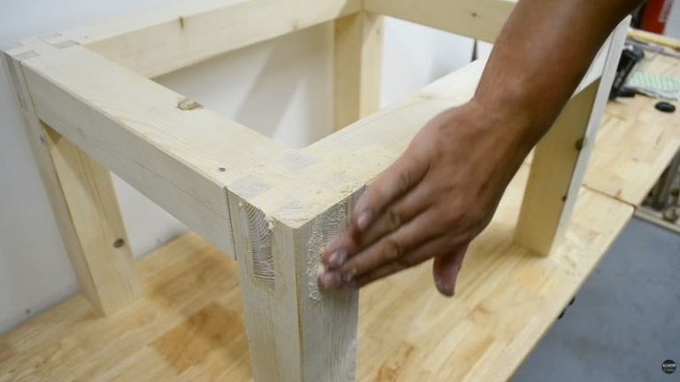 Filling small gaps in castle joints with wood glue and sawdust.