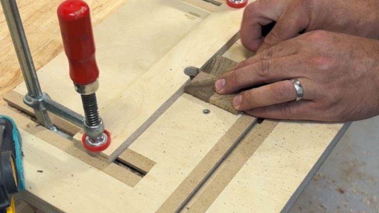 Routing a shallow step around the underside of a walnut keepsake box lid.