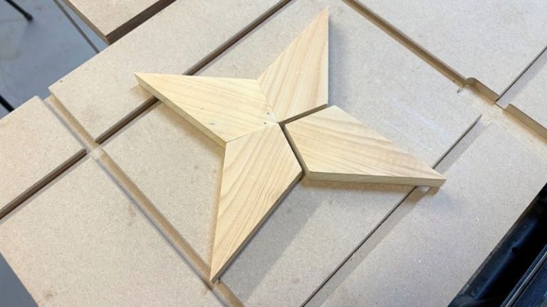 Four spruce pieces arranged to form a 4-point wooden star