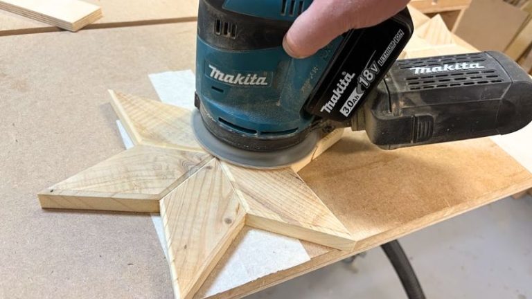 Sanding a wooden Christmas star before finishing