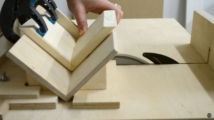DIY table saw spline jig mounted on crosscut sled with Baltic birch base and adjustable stoppers