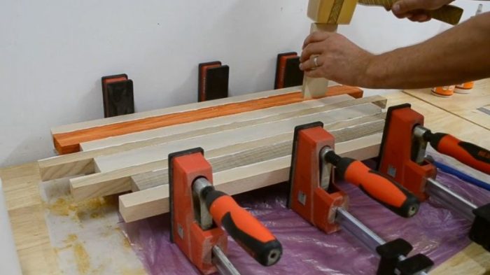 Mixing and reordering strips of padauk, walnut, ash, and beech for a chaotic cutting board pattern.